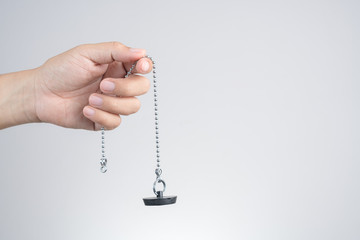 Hand holding basin rubber plug with stainless steel chain