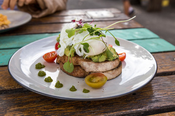 Smashed Avocado and Poached Eggs with cherry tomatoes