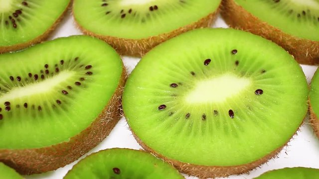 Kiwi kiwis green fruit food closeup texture pattern seamless looping rotating video footage hd resolution.