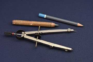 silver, metallic ,School compass on dark blue background