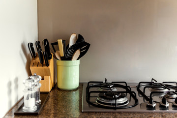 Home kitchen setting with utensils and condiments.