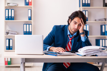 Young handsome businessman sitting in the office