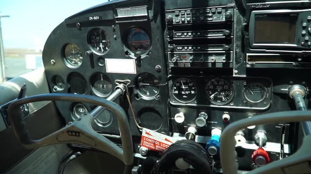 Inside small airplane cockpit with instruments and flight controls