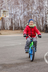 Fototapeta premium six-year-old boy goes on a bike