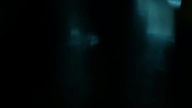 Filmed turquoise lens flare loop with lights softly gleaming and pulsing.