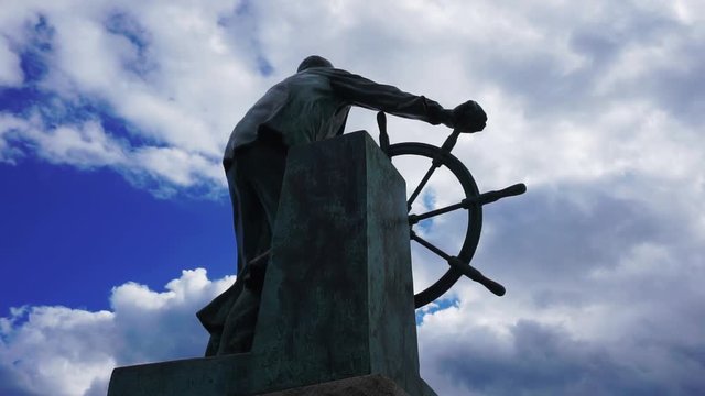 Still shot of the back of the Fishermen&not;&yen;s memorial statue in Gloucester, Massachusetts. Scenic clouds in the background.