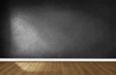 Black wall in an empty room with wooden floor