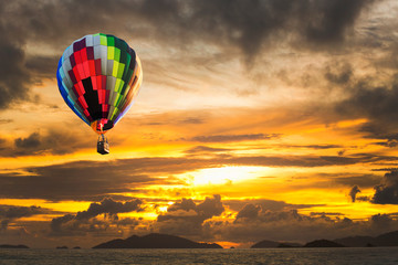 Fototapeta na wymiar Hot air balloons over the ocean at sunset with dramatic sky. Honolulu Hawaii