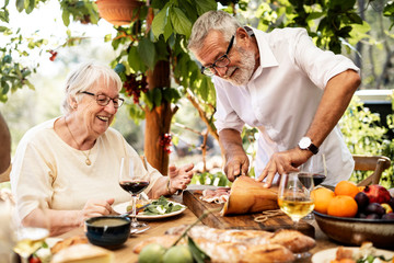 Senior couple having dinner outdoors
