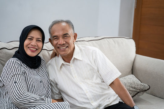 portrait of young asian muslim eldery couple together smiling to camera