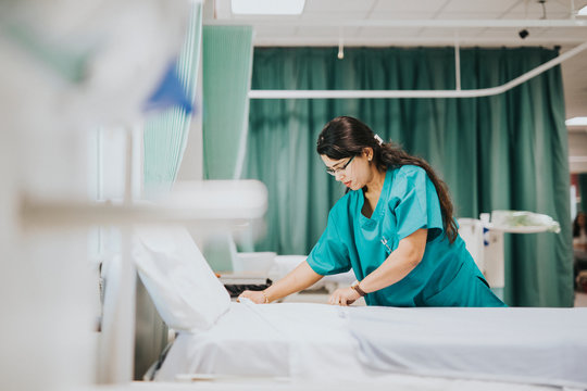Nurse making the bed at a hospital