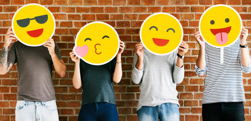 People holding positive emoticons