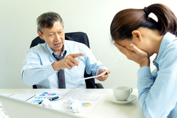 businessman and businesswoman sit quarrel at the table