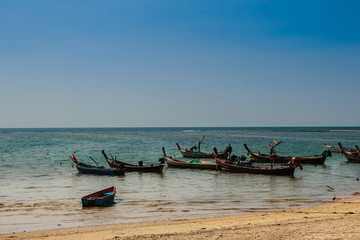 Beautiful view of fisherman boats moored on the beach of fisherman village at Naiyang beach, Phuket, Thailand.