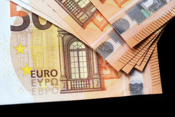 Fifty euro banknotes on a dark background close up