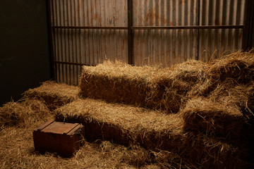 hay stacks in barn house with zinc wall