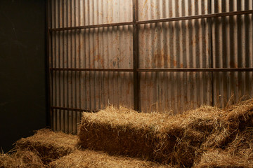 hay stacks in barn house with zinc wall © bennnn