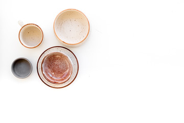Ceramic tableware pattern. Empty plates and mugs on white background top view copy space