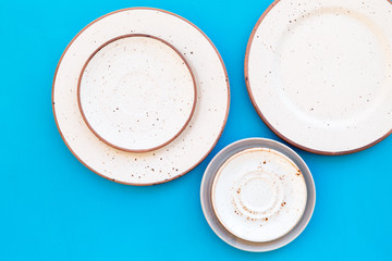Mockup with plates. Empty ceramic plates on blue background top view copy space