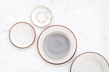 Ceramic plates pattern on white background top view copy space