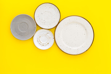 Mockup with plates. Empty ceramic plates on yellow background top view copy space