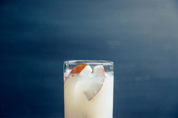 Sweet coconut cocktail on the wooden background. Selective focus. Shallow depth of field.