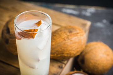 Sweet coconut cocktail on the wooden background. Selective focus. Shallow depth of field.