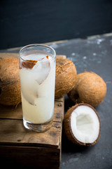 Sweet coconut cocktail on the wooden background. Selective focus. Shallow depth of field.
