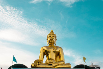 Giant Golden Buddha statue with blue sky Northern Thailand Chairai Province