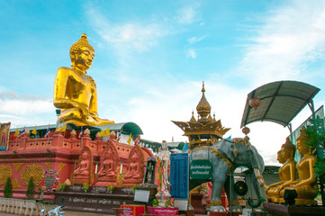Giant Golden Buddha statue with blue sky Thailand