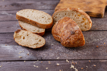 Sliced fresh bread close-up on a dark background. The concept of healthy food and traditional bakery.