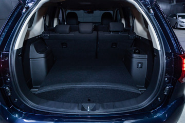 Сlose-up of the car  black interior:   clean luggage boot and car trunk,  front view.