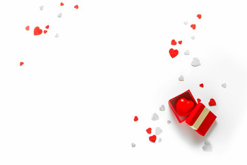 White holiday background with present gift box and little hearts on background. Valentine's day greeting concept. Top view, flat lay, copy space. 