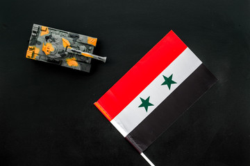 War, military threat, military power concept. Syria. Tanks toy near Syrian flag on black background...