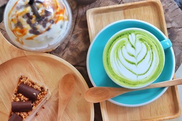 chocolate cake and green tea latte on wood table