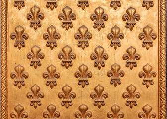 Close up of an ornate golden fleur de lis French royal pattern