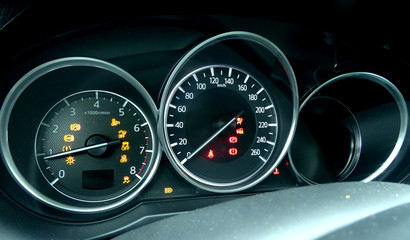 Car dial indication on modern dashboard with backlight inside a vehicle