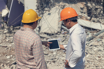 Engineer architect and worker operation control demolish old building.