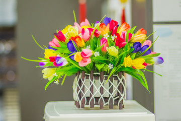 Colorful basket of artificial flower in the office that made better fresh atmosphere  during...
