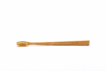 Bamboo toothbrush on white background.