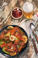Grilled chicken wings spiced with chili peppers and rosemary