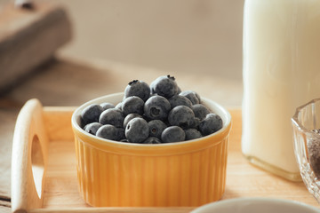 Healthy vegan breakfast. Bottled milk with chia, almond, fresh fruit and berries over wooden table background, copy space. Clean eating, weight loss, vegetarian, raw food concept