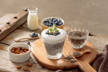 Chia pudding with berries and milk, sweet nourishing dessert, healthy breakfast superfood concept