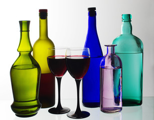Bottles with wine, liqueurs and spirits on a white background.
