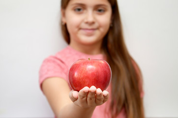  girl on a light background with a red Apple in her hands