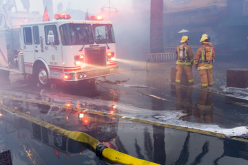 Firefighters next to fire truck