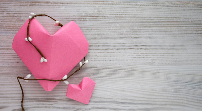 two paper pink heart against a white wood backgraund. Copy space. Free space for text, Close-up, top view