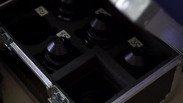 Cinema prime lens being stacked back in the portable case collection and locked securely
(close up shot)