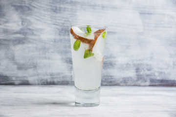 Sweet coconut mojito cocktail on the wooden background. Selective focus. Shallow depth of field.