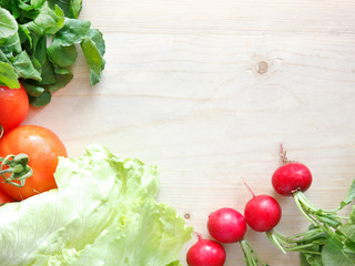 Fresh vegetables on a wooden board - radish, lettuce, arugula, tomatoes